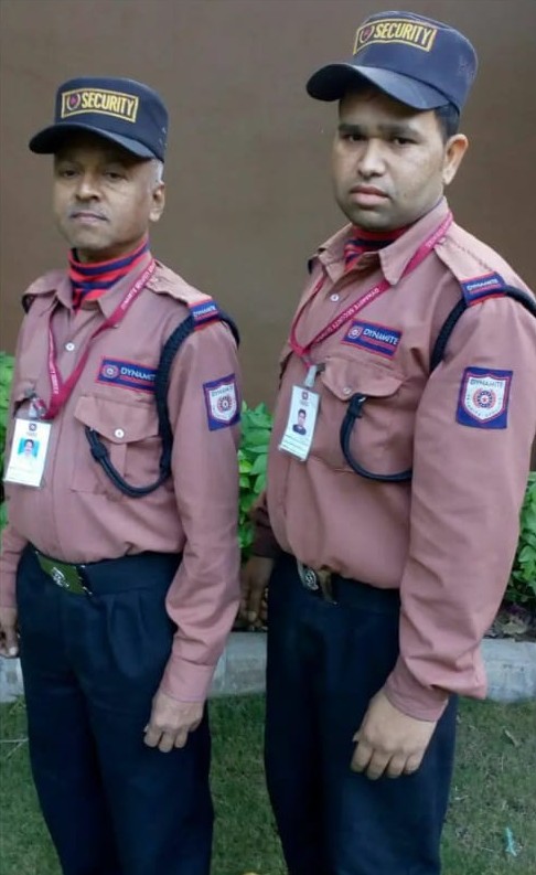 Two Dynamite Security Services guards in uniform at a client site